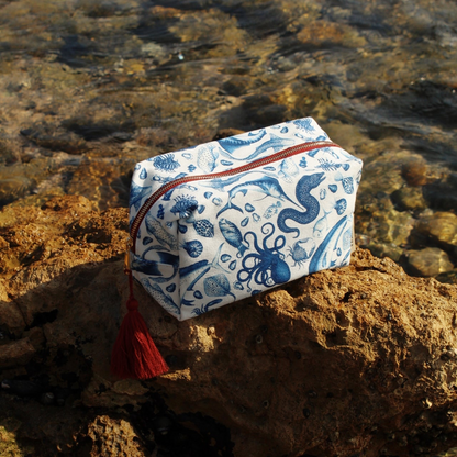 Brescia x Mission Blue Aquatic Affair canvas travel bag featuring hand-painted ocean species including chambered nautilus (Nautilus pompilius), giant Pacific octopus (Enteroctopus dofleini), queen triggerfish (Balistes vetula), Nassau grouper (Epinephelus striatus), blue marlin (Makaira nigricans), and ocean sunfish (Mola mola), supporting Mission Blue ocean conservation. Additional product view.