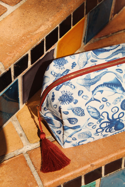 Brescia x Mission Blue Aquatic Affair canvas travel bag featuring hand-painted ocean species including chambered nautilus (Nautilus pompilius), giant Pacific octopus (Enteroctopus dofleini), queen triggerfish (Balistes vetula), Nassau grouper (Epinephelus striatus), blue marlin (Makaira nigricans), and ocean sunfish (Mola mola), supporting Mission Blue ocean conservation. Additional product view.