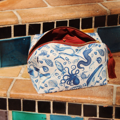 Brescia x Mission Blue Aquatic Affair canvas travel bag featuring hand-painted ocean species including chambered nautilus (Nautilus pompilius), giant Pacific octopus (Enteroctopus dofleini), queen triggerfish (Balistes vetula), Nassau grouper (Epinephelus striatus), blue marlin (Makaira nigricans), and ocean sunfish (Mola mola), supporting Mission Blue ocean conservation. Additional product view.
